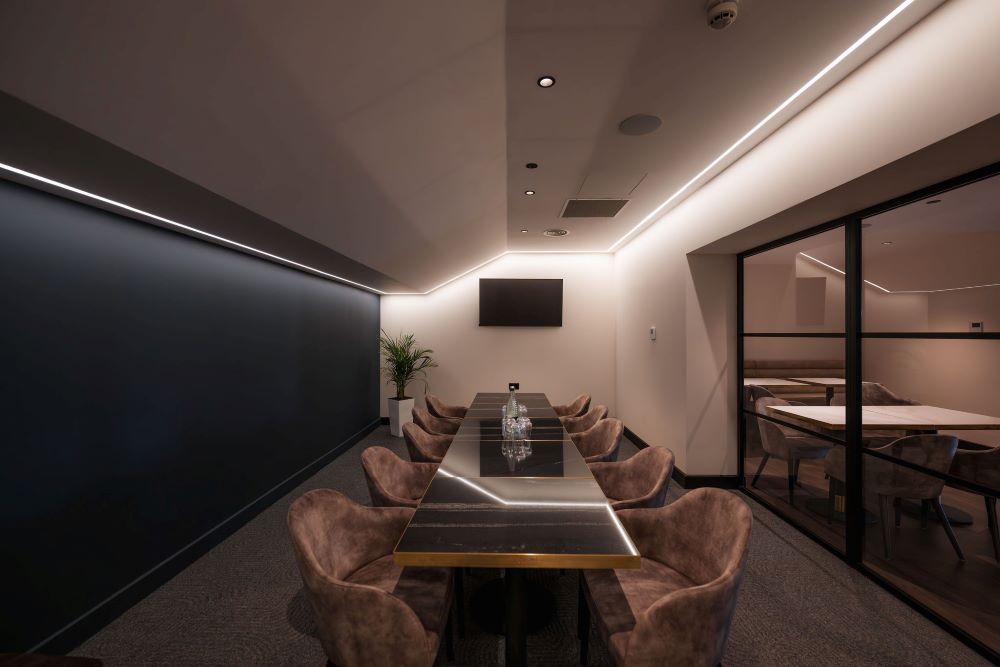 The Alliance Glass Box, a private dining and meeting space with modern décor and glass partitions, perfect for small boardroom sessions or intimate VIP gatherings.